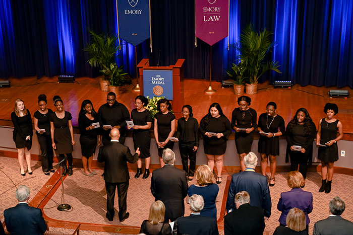 Emory Voices of Inner Strength gospel choir performs in front of the stage at the Emory Medal ceremony