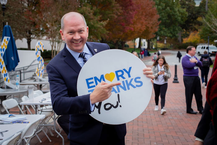 Josh Newton poses with an Emory Thanks sign