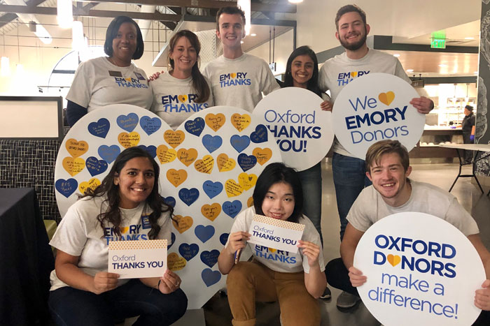 Students at Oxford sign thank you cards to donors