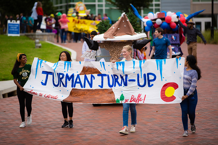 Students carry a sign that says "Turman Turn-Up"