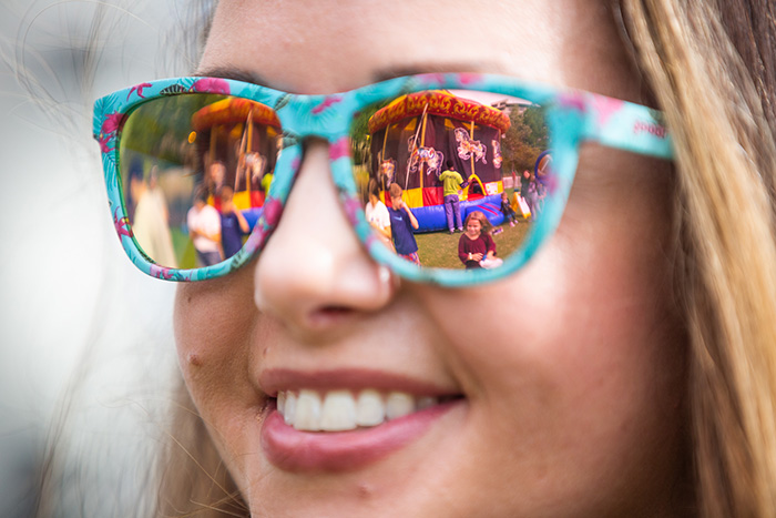 A view of the reflection in a young woman's colorful sunglasses