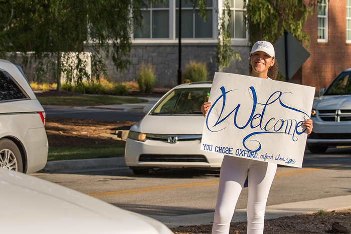 A young student welcomes new students to Emory's Oxford College