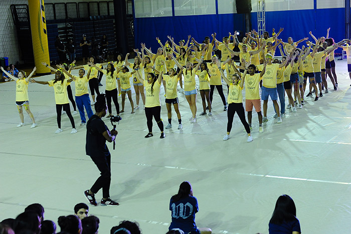 Students from Dobbs hall wear yellow t-shirts and sing together