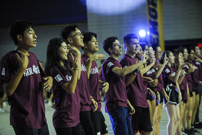Students in maroon Raoul Hall t-shirts dance in sync