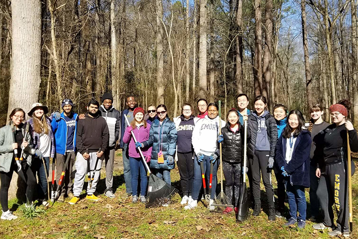 Students pose outside while gardening for the MLK Day of Service