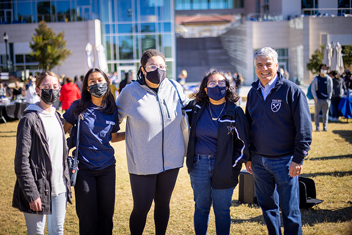 Emory President Gregory L. Fenves poses with students for a photo
