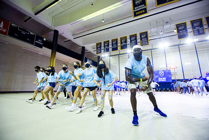 Students from Harris Hall wear light blue shirts and perform at Songfest