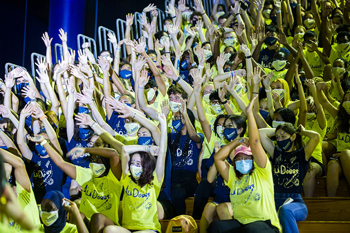 Students from "AlaDobbs" wear yellow shirts and cheer at Songfest