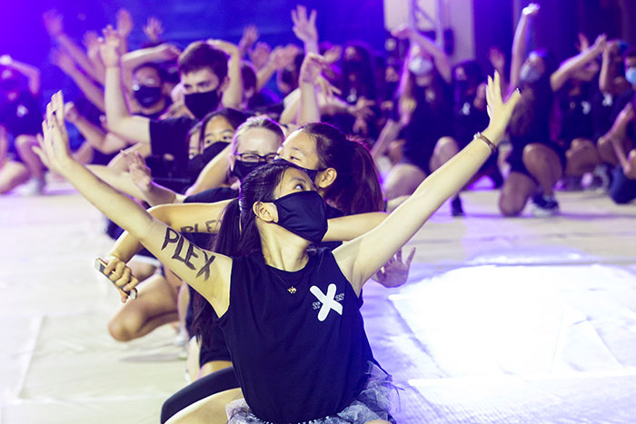 Students from Complex wear black t-shirts and perform a song and dance at Songfest