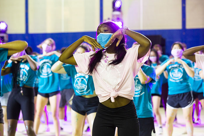 Students wearing light blue t-shirts perform at Songfest