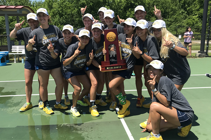 Women tennis players pose with trophy