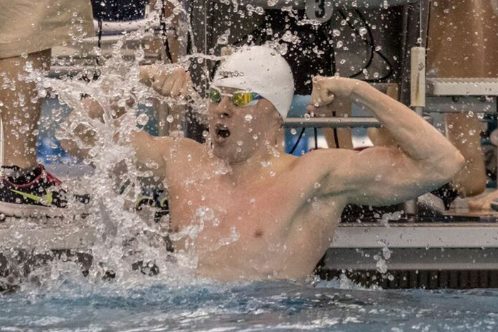 male swimmer flexes muscles