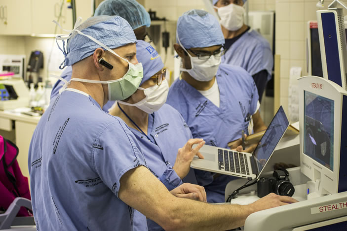 Neurosurgeon Robert Gross (foreground, with earpiece) conducts a majority of the deep brain stimulation surgeries performed at Emory.