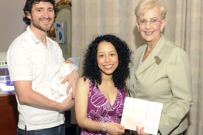 New parents Patricio (left) and Patricia (middle) show off their greeting card and immunization record given to them by First Lady Deal at Emory University Hospital Midtown. The immunization record will help when vaccinating baby Alejandro.
