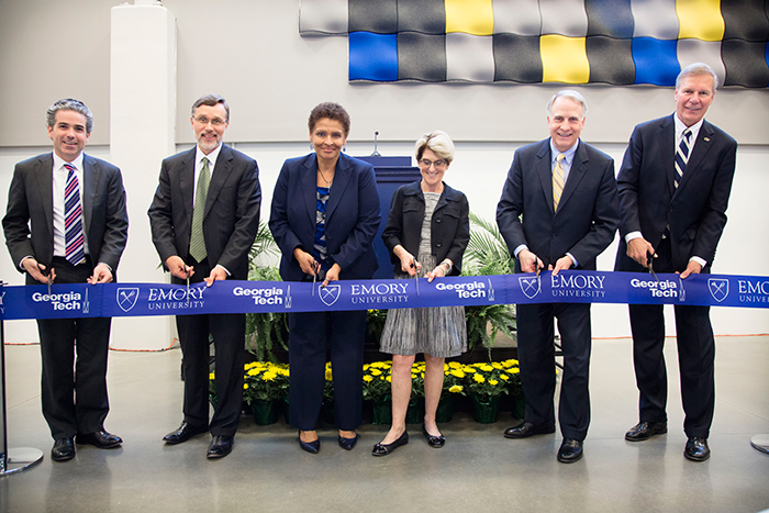 The ceremonial ribbon was cut by, from left, Jack Tillman, president of EmTech; Rich Mendola, Emory senior vice provost of library services and digital scholarship; Yolanda Cooper, Emory University librarian; Catherine Murray-Rust, vice provost for learning excellence and dean of libraries at Georgia Tech; Emory President James Wagner; and Georgia Tech President G.P. "Bud" Peterson.