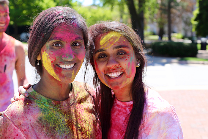 two females covered in colored powder