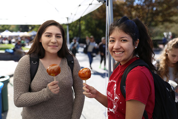 Two female students pose with their caramel apples at Dooleyween.