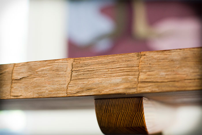 The finish on the table's edge shows the marks of hand-hewing.