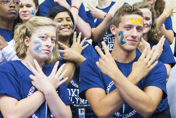 Oxford students all in blue t-shirts with faces painted show support for their team.