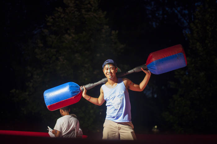 Students compete in a ring with giant padded dumb-bells.