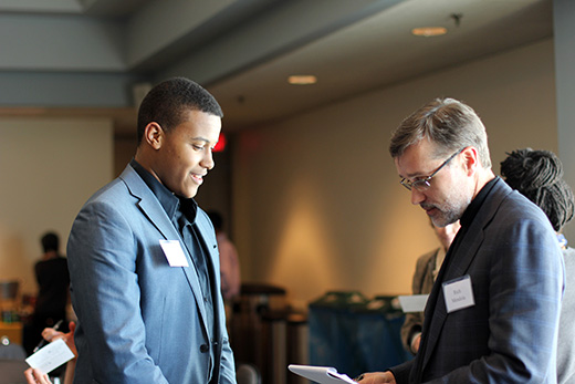 Retreat participants were divided into working groups. Here, student David Watkins talks with Rich Mendola, enterprise CIO and senior vice provost for library services and digital scholarship.