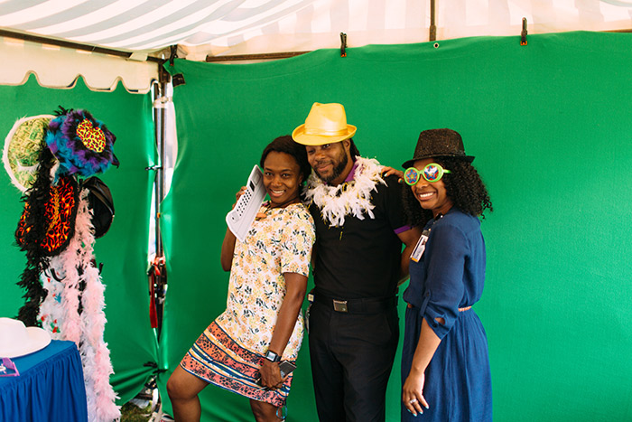 Staff members pose in a photo booth