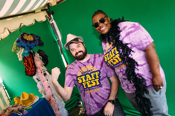 Staff members pose in a photo booth in Staff Fest t-shirts