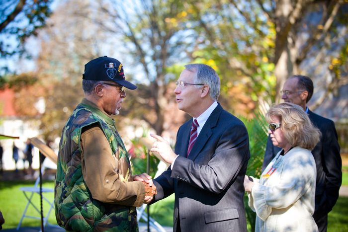 President James Wagner catches up with a veteran in the crowd at the campus Veterans Day Ceremony.