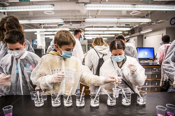 two players in a lab with beakers in front of them