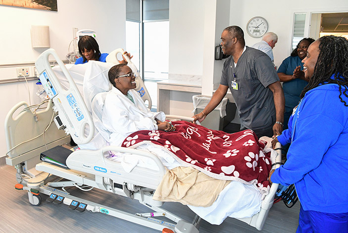 The Emory team readies to care for McCollum in her new patient room in the Emory University Hospital Tower.