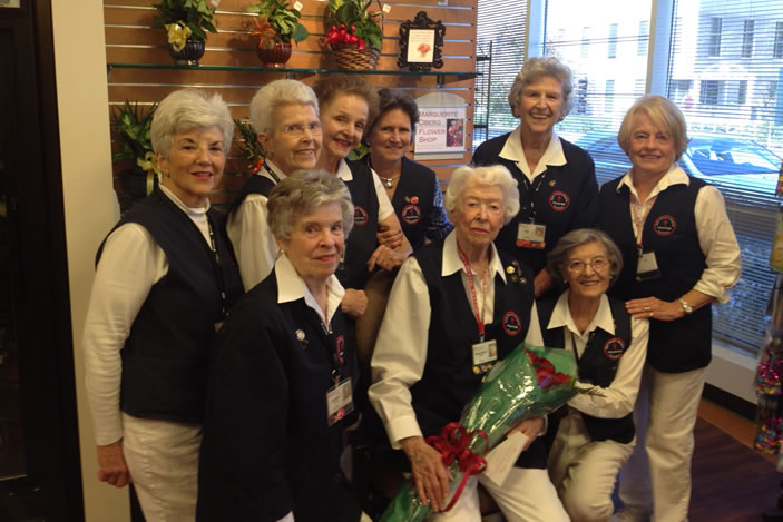 Oberg is joined by flower shop's volunteers who attended the ceremony to name the hospital's flower shop after her.