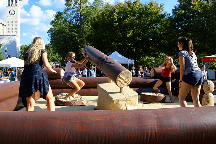 Students attempting to ride "bucking bull" type ride at Camp Swoop.