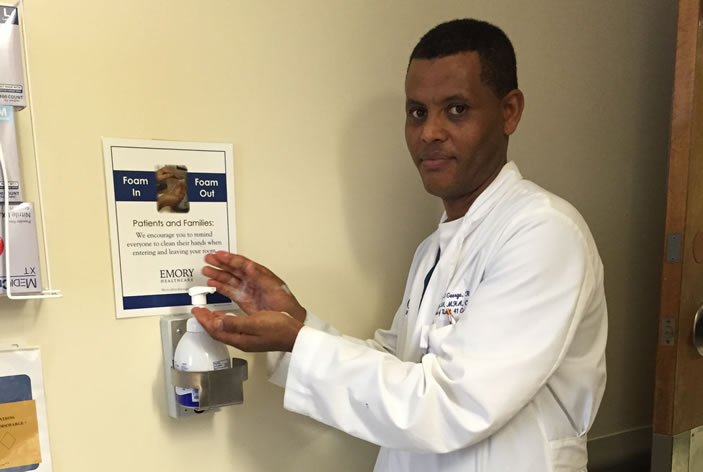 Tadesse St. George, unit director on Unit 41 at Emory University Hospital Midtown, examines the new technology.