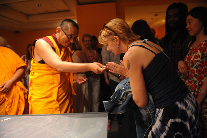 woman bowing towards monk