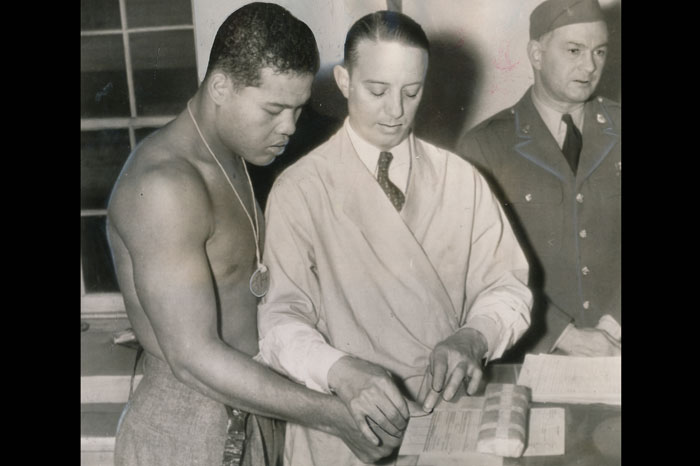 Joe Louis Barrow enlisted in the US Army in January 1942. These photos show him getting a physical examination and being fingerprinted. Photo credit: Pellom McDaniels III collection.