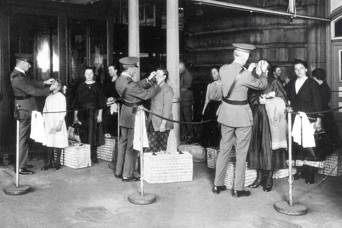 Public Health Service physicians are shown screening immigrants on Ellis Island in this undated photo. Credit: Office of the Public Health Service Historian