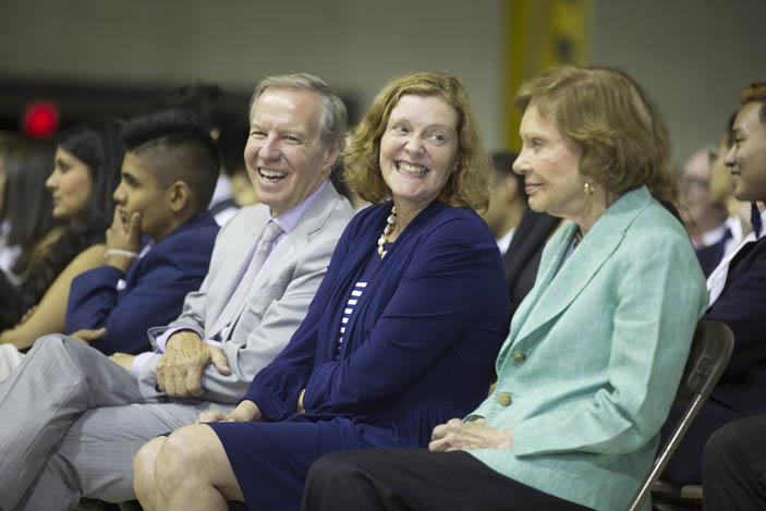 Emory President Claire Sterk speaks with former First Lady Rosalynn Carter in the audience.