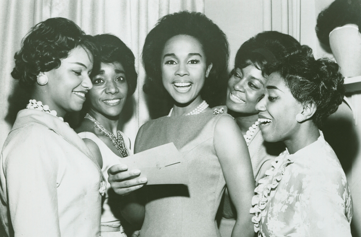 Diahann Carroll (center), pictured with charm school students in this undated photo, started her career as a Grace del Marco model. Credit: Ophelia DeVore papers, MARBL, Emory University.