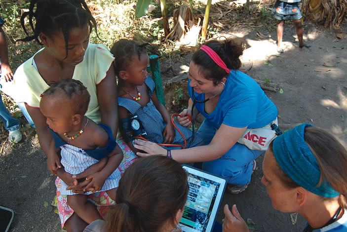 Nursing students conduct blood pressure screenings of children in Haiti and Moultrie, Georgia. The students helped pilot the Pedia BP app in both locations.