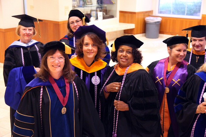 Faculty members Dian Evans, Suzanne Staebler, Lisa Muirhead, Carolyn Clevenger, and (back, from left) Rebecca Gary, and Carolyn Reilly before the School of Nursing Diploma Ceremony at McDonough Field.