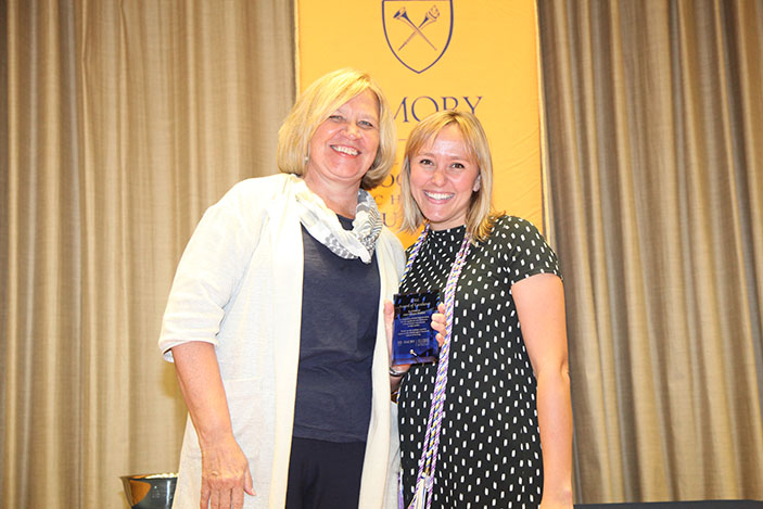 Fuld Service Learning Fellow and an AMSN Family Nurse Practitioner/Nurse Midwifery student Kate Dirks receives the Award of Excellence from Dean Linda McCauley for her academic performance. 