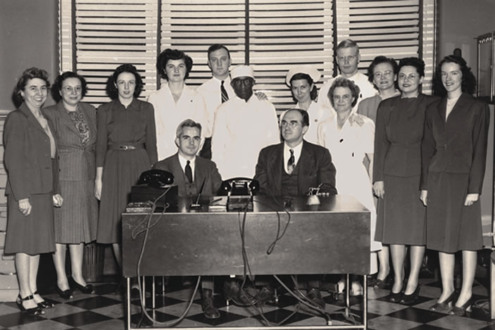 The first staff of the Robert Winship Clinic gathered for a group photo. Dr. Elliott Scarborough is seated on the right.