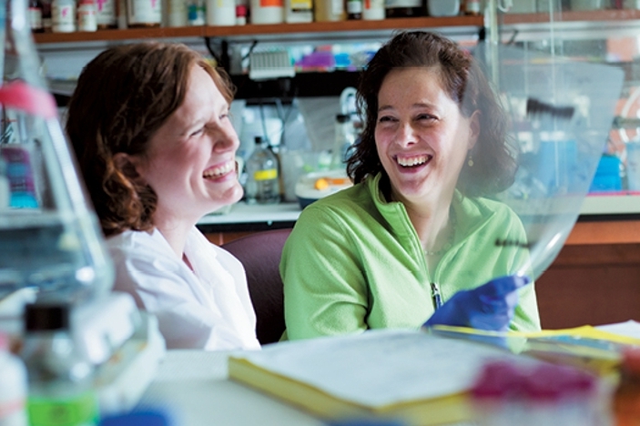 Shannon Matulis (left) shows Deana Chiusano the lab discovery that led to treatment.