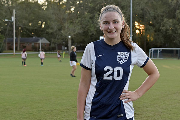 Annie Chappell wears the No. 20 jersey, the same as her dad's baseball number at Emory. 