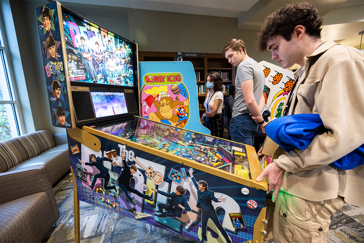 college males playing pinball