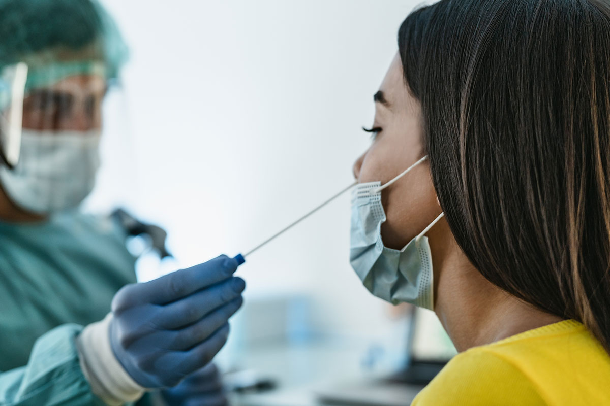 An individual receives a COVID-19 nasal test