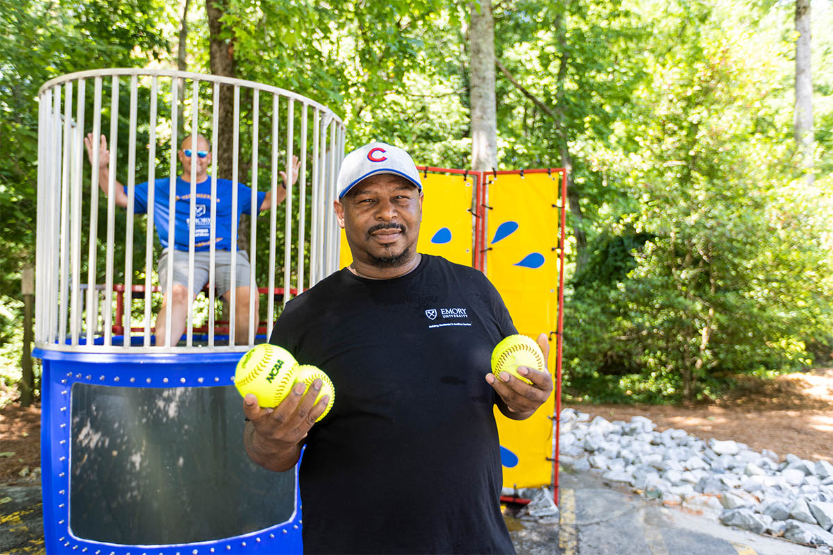 man standing in front of dunking booth