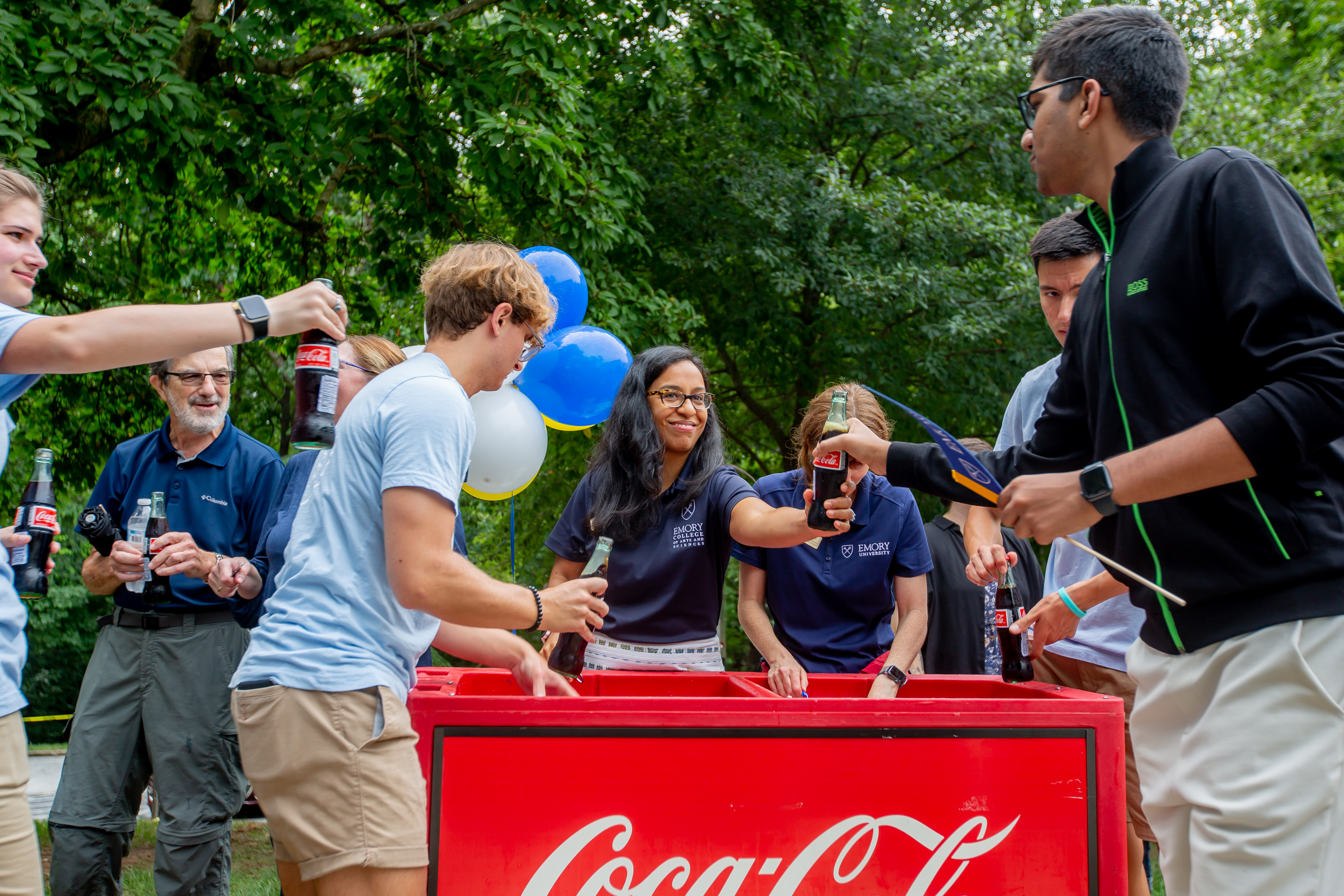 Staff handing out coca-cola 