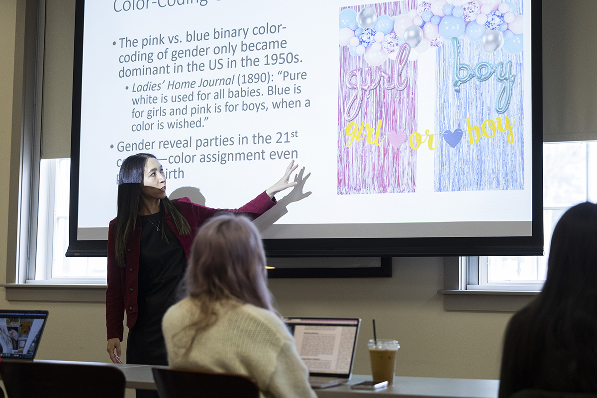 Professor Erica Kanesaka teaching in front of a projector